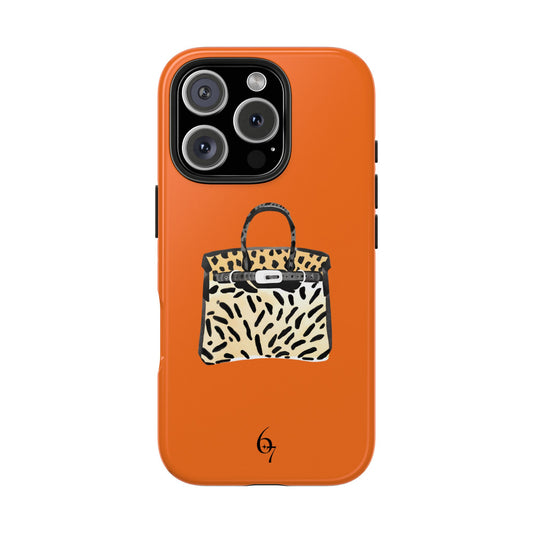 A stylish phone case featuring a cheetah-inspired design with luxury Birkin bag influences. Made with a durable polycarbonate shell and TPU lining, this two-piece case offers impact resistance and shock dispersion. The glossy finish enhances its chic appeal, and an interior rubber liner provides extra protection. Compatible with wireless charging (excluding MagSafe). Available for multiple iPhone models. Cute, unique, and aesthetic.